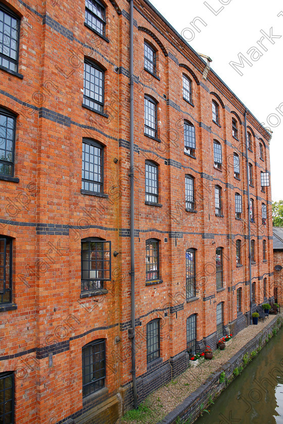 PRFD MG 4605 
 Alongside the Grand Union Cana 
 Keywords: 5 stories tall, Architecture, Canalside appartments, Historic, black windows, brick building, converted factory, converted warehouse, red brick, renovated