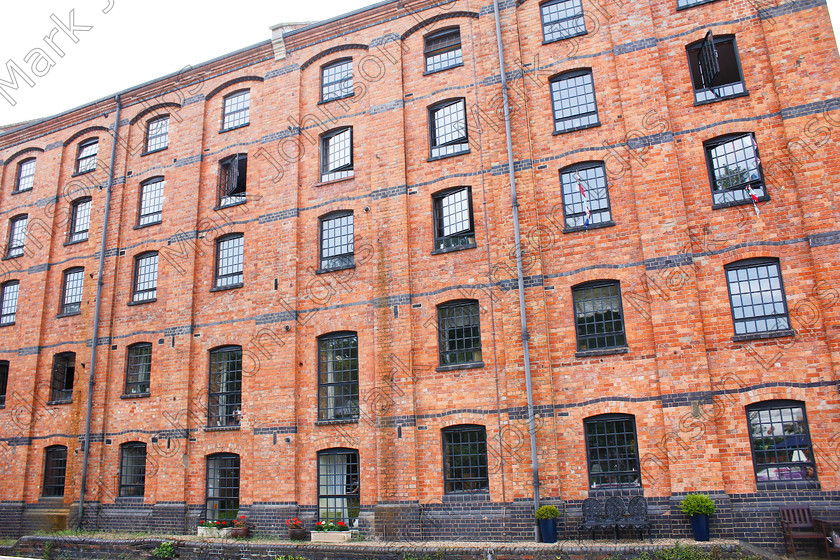 PRFD MG 4590 
 Alongside the Grand Union Cana 
 Keywords: 5 stories tall, Architecture, Canalside appartments, Historic, black windows, brick building, converted factory, converted warehouse, red brick, renovated